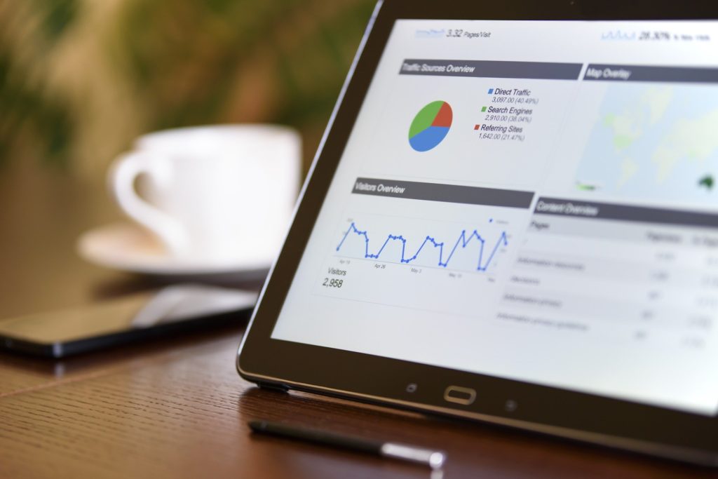 A tablet on a desk depicts marketing analytics, tracking, and research.